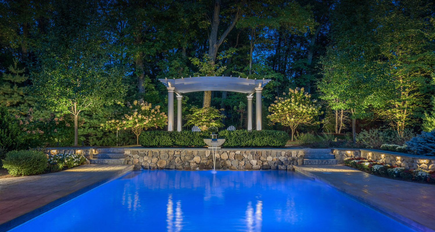 residential landscape lighting by a fountain pool